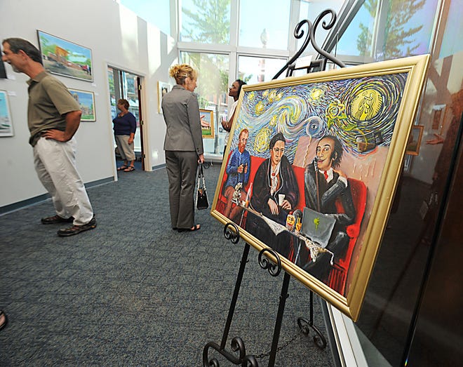 Visitors to the Taunton BID open house art show enjoy the paintings and other pieces of art.