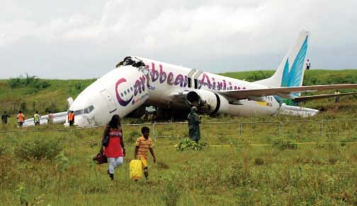 The broken fuselage of a Caribbean Airlines' Boeing 737-800 is
seen after it crashed at the end of the runway at Cheddi Jagan
International Airport in Timehri, Guyana, Saturday.