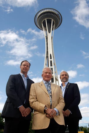 Ron Sevart, CEO of Space Needle, left, Buzz Aldrin, former astronaut, center, and Richard Garriott, first second-generation space traveler, pose outside the Space Needle on Sunday, July 31, 2011, in Seattle. Aldrin and Garriott were at the Space Needle to help promote a contest sponsored by the Needle to celebrate its 50th anniversary by sending a member of the general public into space. The contest will be announced Monday, August 1, 2011 at 10 a.m.. (AP Photo/Joe Nicholson)