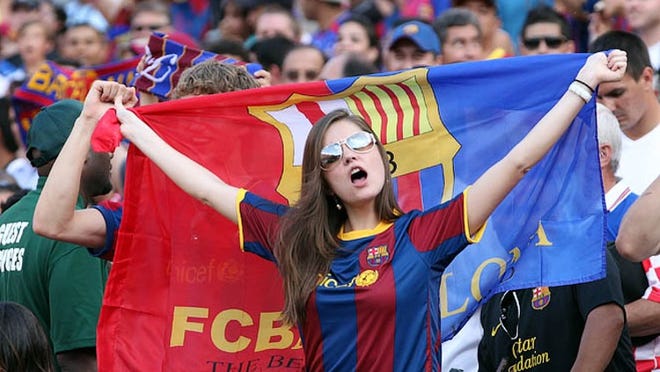 A Barcelona fan cheers before the squad takes on Manchester United in a friendly on July 30, 2011, in Landover, Md. Barcelona will play another friendly on Wednesday, Aug. 3, in front of an expected 60,000 fans at Sun Life Stadium.