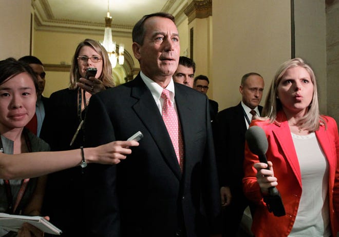 Speaker of the House John Boehner, R-Ohio, returns to his office after emergency legislation to avert a government default and cut federal spending passed a showdown vote in the House of Representatives, at the Capitol, in Washington.