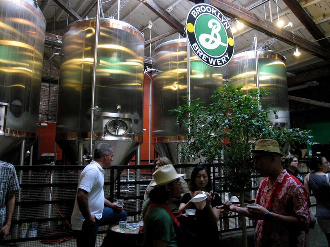 This June 25, 2011 photo shows visitors sampling beer at the Brooklyn Brewery in the Brooklyn borough of New York. The brewery is located in a 150-year-old factory in Williamsburg, a working-class section of Brooklyn with a gritty industrial past that has become popular among hipsters and is starting to attract tourists. The brewery also offers weekend tours that attract visitors from around the world. (AP Photo/Beth Harpaz)