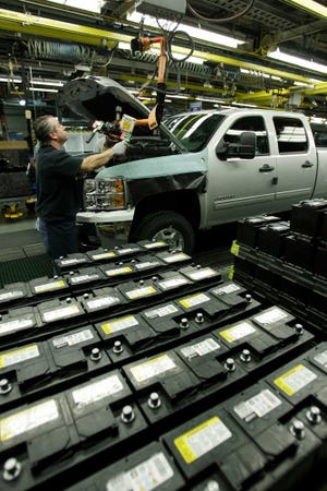 Batteries are installed in the 2011Chevrolet Silverado and GMC Sierra heavy-duty pickups assembly line at the Flint Assembly in Flint, Mich. Analysts predict sales of new cars and light trucks in the U.S. rose slightly from a year earlier as few deals and economic worries kept car shoppers home.