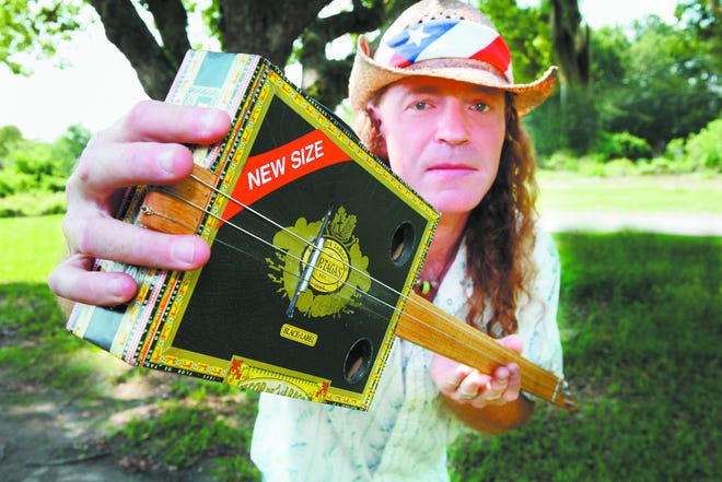 Roy Swindelle with his cigar box guitar.