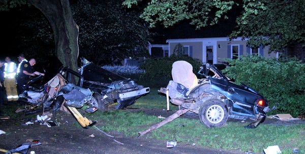 Douglas Andrade's car split in two after striking a utility pole and a tree on Davisville Road in Falmouth early Wednesday morning. A Falmouth police officer was following Andrade, who was traveling 76 mph on the 30 mph road, according to a police report on the crash.