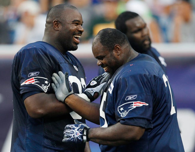 Patriots defensive lineman Albert Haynesworth, left, jokes with nose tackle Vince Wilfork during a blocking drill during the team's workout that was open to season ticket holders at Gillette Stadium on Wednesday night.