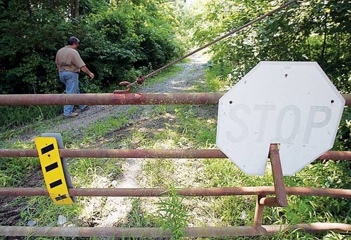 Photo by Daniel Freel/ New Jersey Herald - Kevin James, general manager of the proposed site of the Beaver Run Solar Farm, walks on a closed-off portion of Fox Hill Road in Lafayette.
