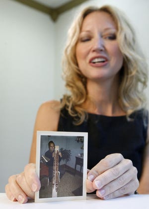 Marla Cooper holds a photograph of her late uncle Lynn Doyle Cooper during an interview in Oklahoma City, Wednesday, Aug. 3, 2011. Cooper said she believes that her late uncle Lynn Doyle Cooper was the man who hijacked a plane in 1971 and parachuted away with $200,000 ransom into a rainy night over the Pacific Northwest.