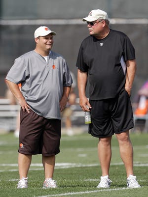 Cleveland Browns general manager Tom Heckert (left) talks with president Mike Holmgren during practice at the team's training camp Monday in Berea.