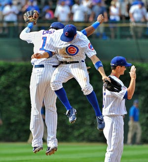 Chicago Cubs' Starlin Castro, left, Tony Campana, center, and Darwin Barney celebrate their win over the Cincinnati Reds after a baseball game on Friday, Aug. 5, 2011 in Chicago. The Cubs won 4-3.