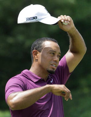 Amy Sancetta/The Associated Press Tiger Woods wipes his brow Thursday during the Bridgestone Invitational at Firestone Country Club in Akron, Ohio.