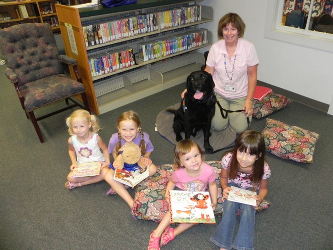 Children at Douglas Library read to Zenny.
