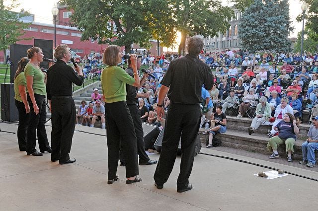Monika O'Clair/Democrat photo 
The a cappella group Tuckermans at 9 perform for a crowd at Henry Law Park in downtown Dover Friday evening.