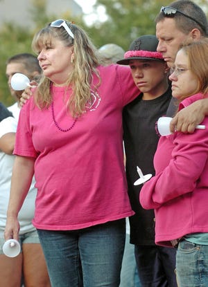 Quincy resident Edie Wallace, left, stands with family members during a vigil to remember those lost to drug abuse, outside Quincy City Hall, Friday, Aug. 5, 2011. Wallace said she lost her daugher Jennifer Marie Wallace at age 25 to heroin addiction in November 2009.