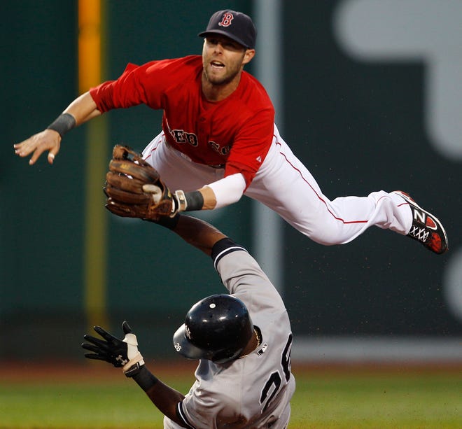 Boston Red Sox second baseman Dustin Pedroia, top, leaps over New York Yankees' Eduardo Nunez as he makes the force and throws to first in the third inning of a baseball game at Fenway Park in Boston, Friday, Aug. 5, 2011.
