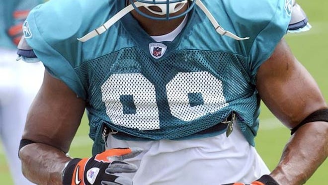 Jason Taylor goes through drills during Dolphins training camp on Saturday, Aug. 6, 2011, in Davie.