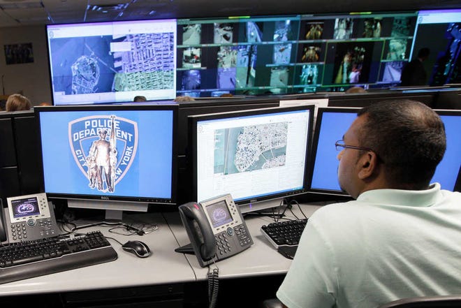 This Thursday, July 28, 2011 photo show a police officer monitoring live video taken from cameras placed around New York City at the Lower Manhattan Security Coordination Center, in New York. (AP Photo/Mary Altaffer)