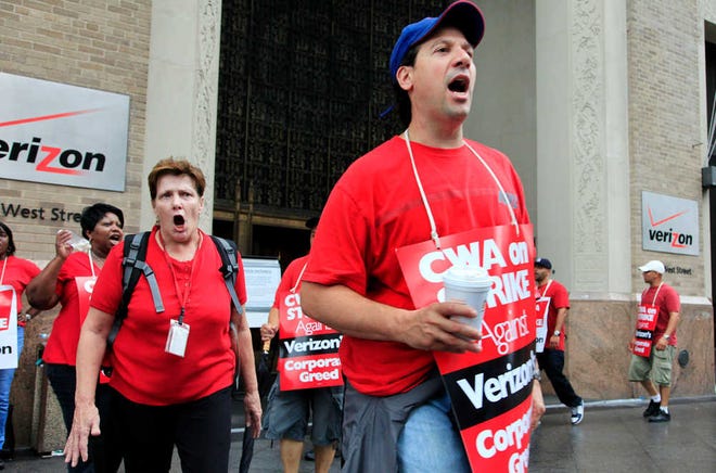 Verizon workers picket in front of the company's headquarters, Sunday, Aug. 7, 2011, in New York. Forty-five thousand Verizon Communications Inc. workers from Massachusetts to Washington, D.C., went on strike Sunday after negotiations fizzled over a new labor contract for more than a fifth of the company's work force. (AP Photo/Mark Lennihan)