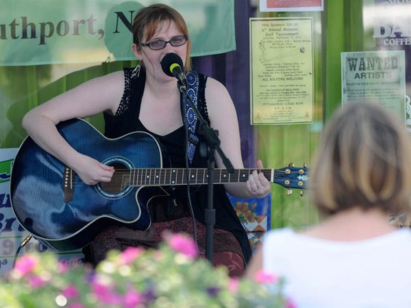 Sophie Harton plays in front of Taylor's Cuisine during Shop to the Beat in Southport on Thursday, Aug. 4, 2011. The twice-a-month event combines shopping deals with live music.