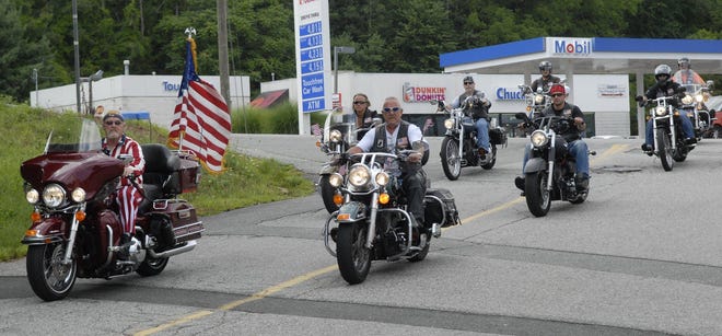Mike Smith of Norwich, left, as "Uncle Sam", and Bob Spiess of Montville, Director of Legion Riders, right, pulls into the Montville American Legion Post 112 Sunday, August 7, 2011 after their 1st Annual New London County Veterans Fallen Heroes Scholarship Run. The ride hosted by the No Where Cafe of New London and the Montville American Legion Post 112 in honor of 6 service men from New London County killed in action.