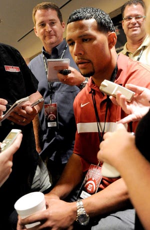 FILE - This July 26, 2011, file photo shows Oklahoma linebacker Travis Lewis talking with reporters during the NCAA college football Big 12 Media Days, in Dallas. Oklahoma defensive captain and leading tackler Travis Lewis will miss up to eight weeks with a broken bone in his left foot, leaving the Sooners without one of their best defensive player for a few crucial early season games. (AP Photo/Matt Strasen, File)