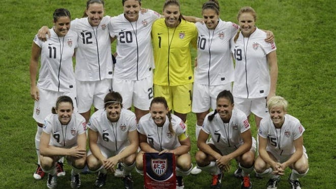 United States' Alex Krieger, Lauren Cheney, Abby Wambach, goalkeeper Hope Solo, Carli Lloyd, Rachel Buehler from top left, and, from bottom left, Heather O Reilly, Amy Le Peilbet, Christie Rampone, Shannon Boxx, Megan Rapinoe, pose for a team photo prior to the final match between Japan and the United States at the Women’s Soccer World Cup in Frankfurt, Germany, Sunday, July 17, 2011. (AP Photo/Michael Sohn)