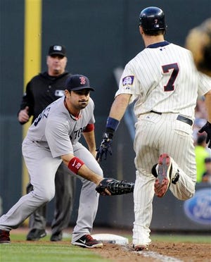 Adrian Gonzalez prepares to tag out Twins' Joe Mauer who hit into an infield grounder in the third inning of Wednesday's game in Minneapolis.