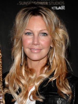 In this Oct. 17, 2010 file photo, actress Heather Locklear arrives at the WTB Spring 2011 Fashion Show at Sunset Gower Studios in Los Angeles. Locklear is engaged to fellow "Melrose Place" actor Jack Wagner. Locklear spokeswoman Sarah Fuller confirmed the engagement on Friday but offered no other details. (AP Photo/Dan Steinberg, file)