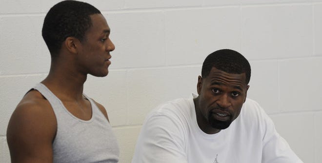 Boston's Rajon Rondo, left, and Milwaukee's Stephen Jackson chat at the Kendrick Perkins' second annual youth basketball camp on Friday. Training camps are due to open in the first week of October, and Rondo and Jackson have set an Oct. 1 deadline for deciding if they'll play in Europe or elsewhere, or wait out the labor impasse that threatens to wipe out games and possibly, the entire 2011-12 season.