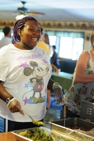 Umayma Wilkerson-Dixon, 14, of Pittsburgh, served lunch on the
last day of summer camp at Pine Valley Bible Camp in North
Sewickley Township. She is in training to some day be a member of
the staff.