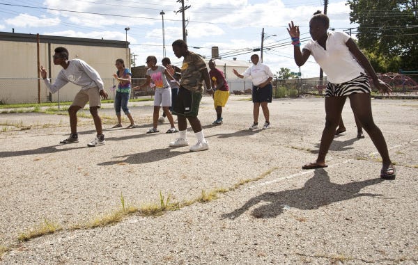 Students practice a dance routine outside the Boys and Girls Club on the West Side. The group plans to show the routine, based on a Beyonce music video, during a flash mob.