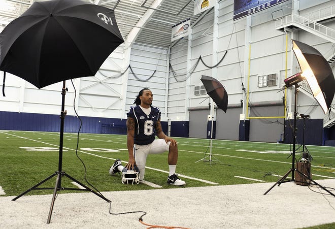 Connecticut football player Kashif Moore poses for a photograph during the NCAA college football team's media day in Storrs, Conn., Friday, Aug. 12, 2011.