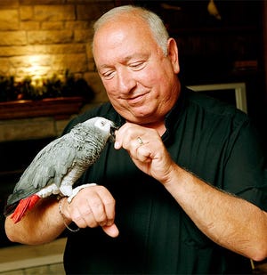 The Rev. Rodric J. DiPietro, shown here in 2009 with a parrot that lived with him at St. Brendan, was remembered as a friendly pastor with a special love for animals.