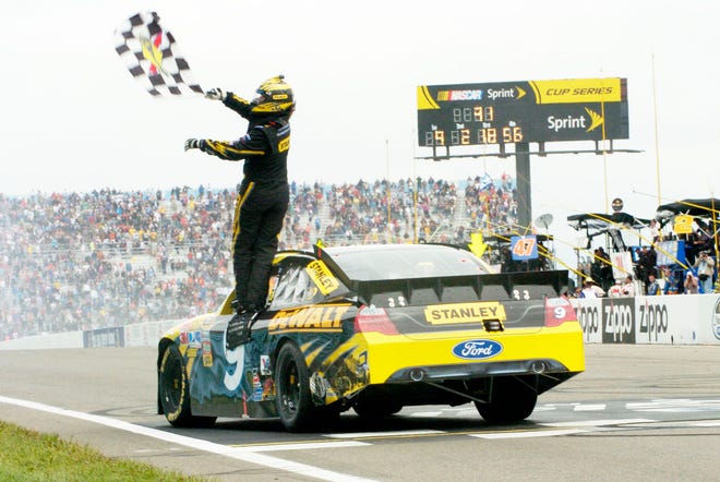 Marcos Ambrose, of Australia, celebrates after winning the NASCAR Sprint Cup Series auto race at Watkins Glen International in Watkins Glen, N.Y., on Monday.