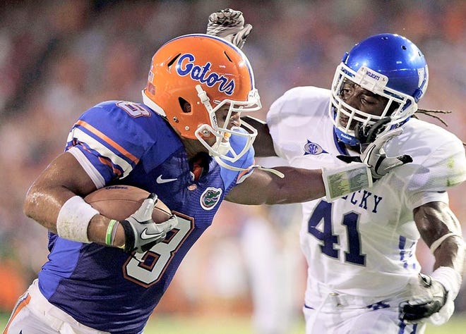Florida's Trey Burton, left, runs past Kentucky cornerback Mychal Bailey during a game last season. He'll continue to be a versatile player for the Gators in 2011, lining up at numerous positions.