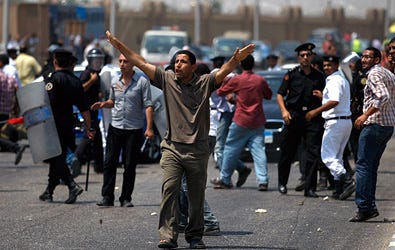 An anti-Mubarak protester during clashes with pro-Mubarak protesters outside the police academy in Cairo, Egypt, on Monday.