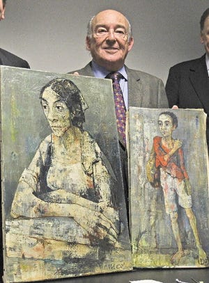 Michael Bakwin holds up two paintings that were returned to him on Nov. 17, 2010. The artwork by Jean Jansem were among seven paintings stolen from Bakwin in 1978.