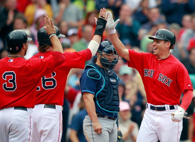 Boston Red Sox's Jacoby Ellsbury, right, celebrates his three-run home run that drove in Mike Aviles (3) and Josh Reddick (16) as Tampa Bay Rays catcher Kelly Shoppach, center, looks on in the third inning of the first game of a baseball doubleheader in Boston, Tuesday, Aug. 16, 2011.