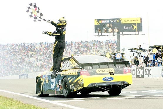 Marcos Ambrose celebrates after winning the NASCAR Sprint Cup Series race Monday at Watkins Glen International. Photos by TOM RYDER, The Associated Press