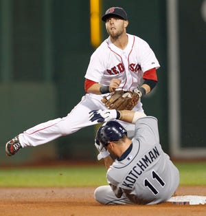 Boston Red Sox second baseman Dustin Pedroia, top, forces Tampa Bay Rays' Casey Kotchman (11) at second and watches his throw to first to complete a triple play against the Rays during the fourth inning of the second baseball game of a doubleheader in Boston on Tuesday, Aug. 16, 2011. Pedroia threw out Rays' Sean Rodriguez at first to get the final out.