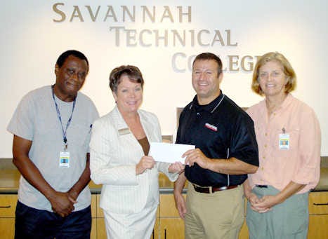 Joe Haddad, branch manager for Grainger Inc., presents a $10,000 check to Savannah Technical College President Kathy Love. The Grainger Foundation funding will be used to support scholarships for industrial technology students. Two current Grainger Scholarship recipients joined in the check presentation. Left is Arthur Green, a student in the college's air-conditioning technology program; right is Kathryn Hardigan, a student in the electrical construction and maintenance technology program. Grainger has been serving Georgia businesses for more than 75 years, providing supplies and equipment needed to keep their facilities running. The company has 11 locations across the state, including its Savannah location. (Special to West Chatham Neighbor)