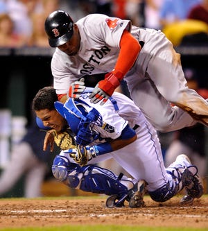 Kansas City Royals catcher Salvador Perez holds onto the ball for the out against Carl Crawford of the Red Sox in the fourth inning on Thursday night.