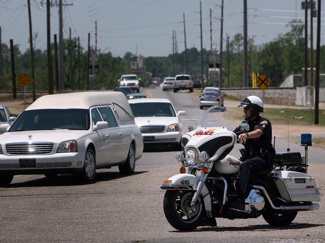 Officer Jeremy Frost of the Tuscaloosa Police Department’s traffic division blocks traffic as other members of the division escort a funeral procession at the corner of 35th Street and Kauloosa Avenue on May 28. Police soon may no longer provide funeral escorts in Tuscaloosa.