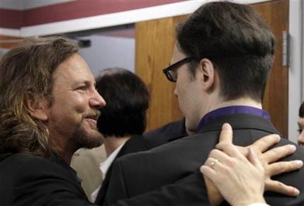 Eddie Vedder of the rock band Pearl Jam, left, embraces Damien Echols, one of three men released Friday, Aug. 19, 2011, at the Craighead County Court House in Jonesboro, Ark., after pleading guilty to crimes they say they did not commit. The three men, convicted of killing three 8-year-old Cub Scouts and dumping their bodies in an Arkansas ditch in 1993, were freed from nearly two decades in prison Friday, after they agreed to plead guilty to secure the release Echols from death row. Vedder became a key supporter of the men after watching a pair of documentaries about the case.