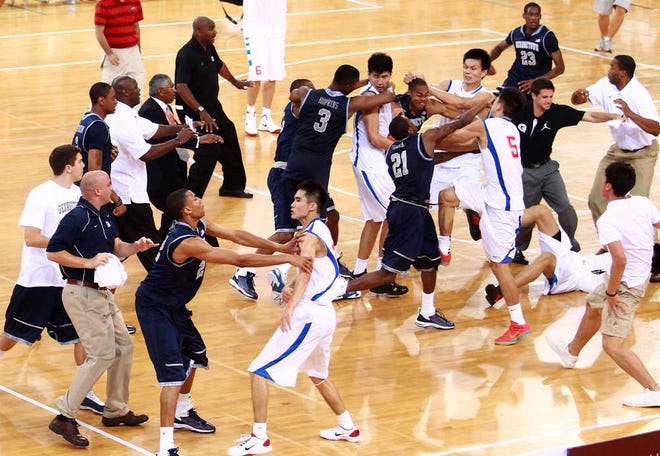 Players of the Georgetown University men's basketball team and China's Bayi Rockets fight during their exhibition game in Beijing, China, Thursday, Aug. 18, 2011. The bench-clearing brawl at the exhibition game between American and Chinese basketball teams marred the orchestrated harmony of U.S. Vice President Joe Biden's visit to China. The fight forced the game to end early. (AP Photo/CD-ANPF)