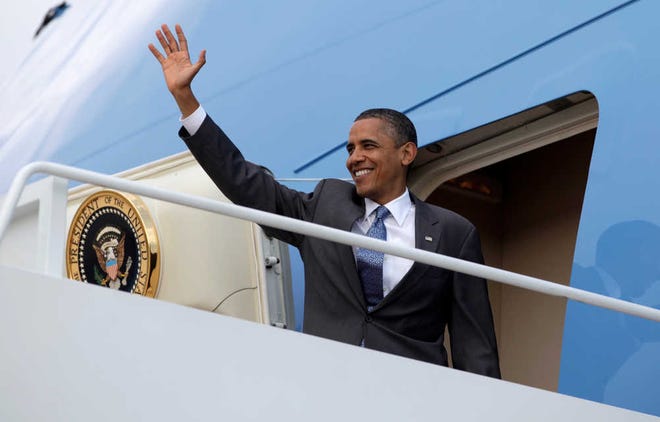 President Barack Obama waves as he boards Air Force One at Andrews Air Force Base, Md.
