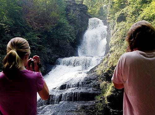 Photo by Daniel Freel/New Jersey Herald - Marissa Sarna-McCarthy, 14, left, and her mother, Melanie Sarna, both of South Hampton, Mass., film a waterfall during a guided tour at Dingmans Falls in the Delaware Water Gap National Recreation Area Sunday.