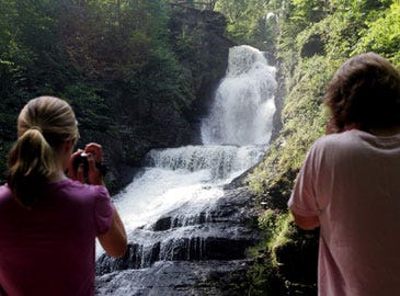 Photo by Daniel Freel/New Jersey Herald - Marissa Sarna-McCarthy, 14, left, and her mother Melanie Sarna, both of South Hampton Ma., film a waterfall during a guided waterfall tour at Dingmans Falls Pa. in the Delaware Water Gap National Recreation Area.