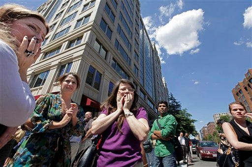 Office workers gather on the sidewalk in downtown Washington, Tuesday, Aug. 23, 2011, moments after a 5.9 magnitude tremor shook the nation's capitol. The earthquake was centered northwest of Richmond, Va.