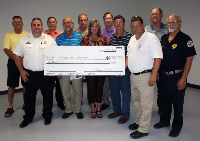 Industry and local officials made donations last week for the new 5th Ward Burnside Fire Station 41. Shown from left to right: Bill Dawson, Pelican Point Homeowners Association; Fifth Ward Fire Chief Peter Roblin; Ascension Parish President Tommy Martinez; Randy Gautreau, Acadian Builders; Ormet Vice President Tommy Temple; Tami Templet, Ormet Human Resources; Trafigura Plant Manager Brian Carnohan; Ascension Parish Councilman Kent Schexnaydre; James LeBlanc, Ascension Parish Fire District No. 1; Ormet Plant Manager Darrel Harriman and Eugene Witek, Fire Coordinator for Ascension Parish Fire District No. 1.